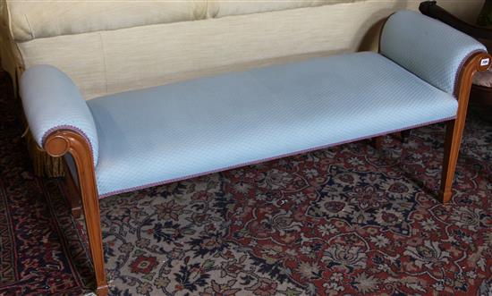 A blue fabric upholstered window seat